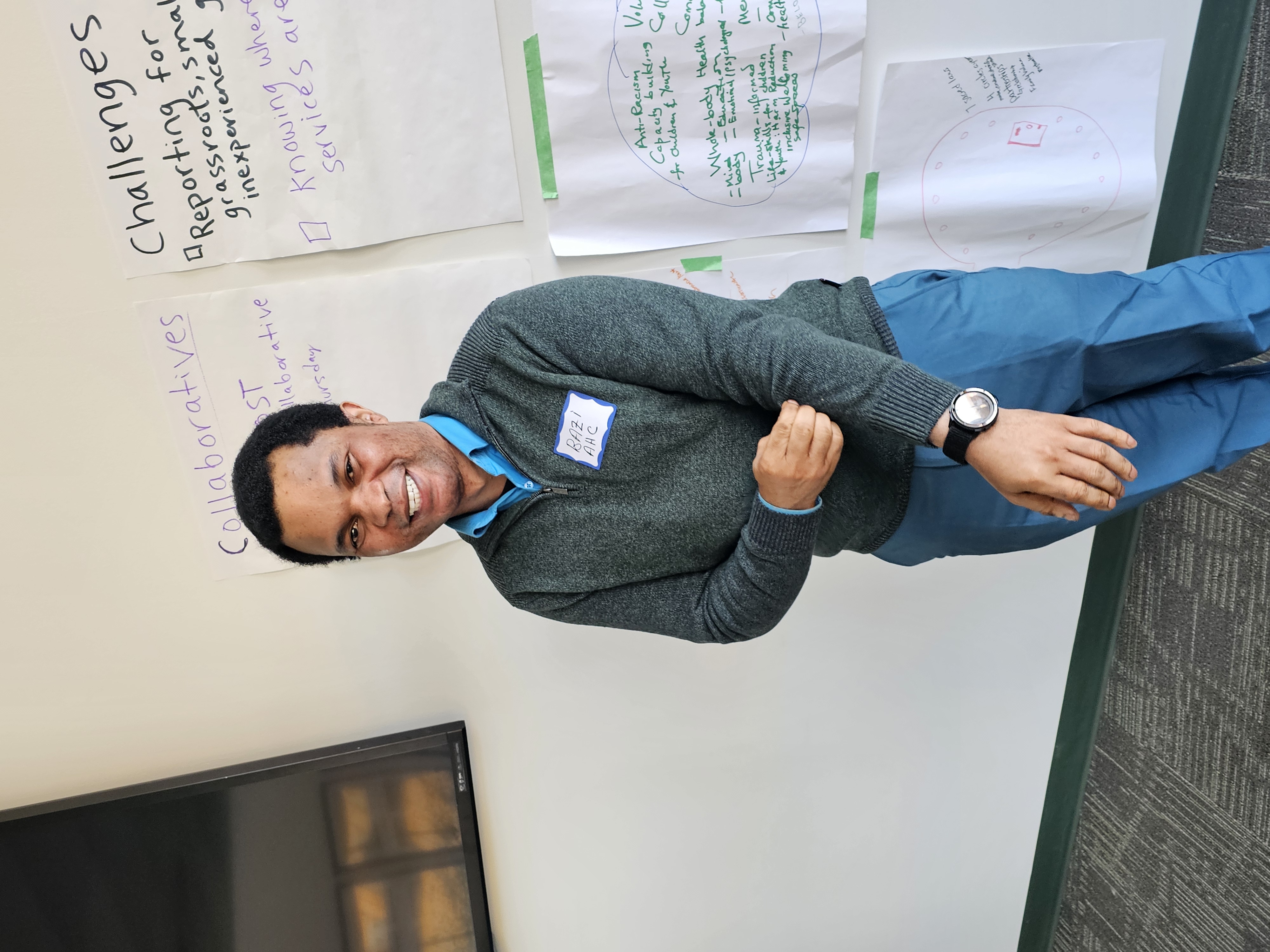 Bazi standing in front of a white board