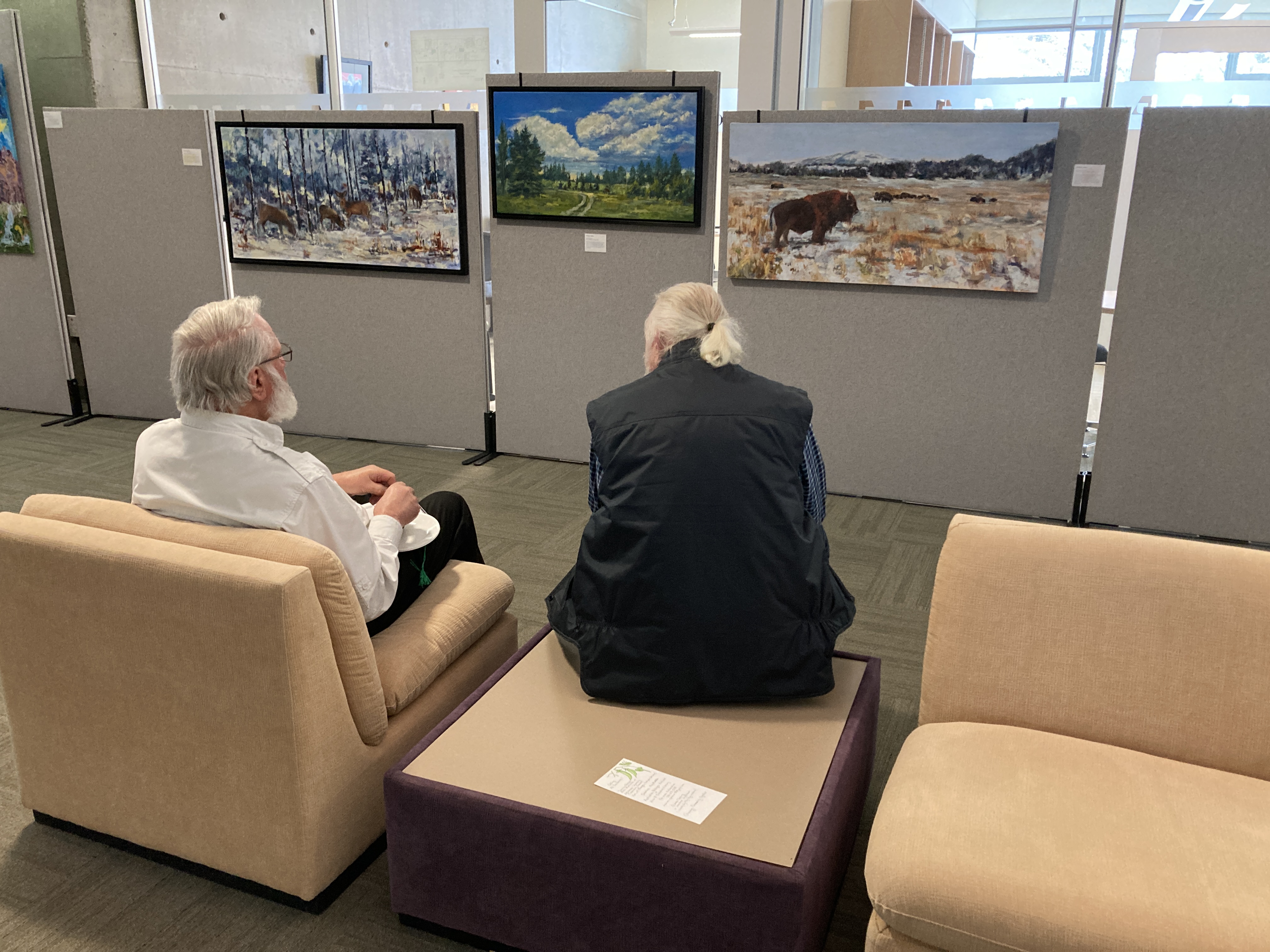 A group of attendees looking at art in the gallery