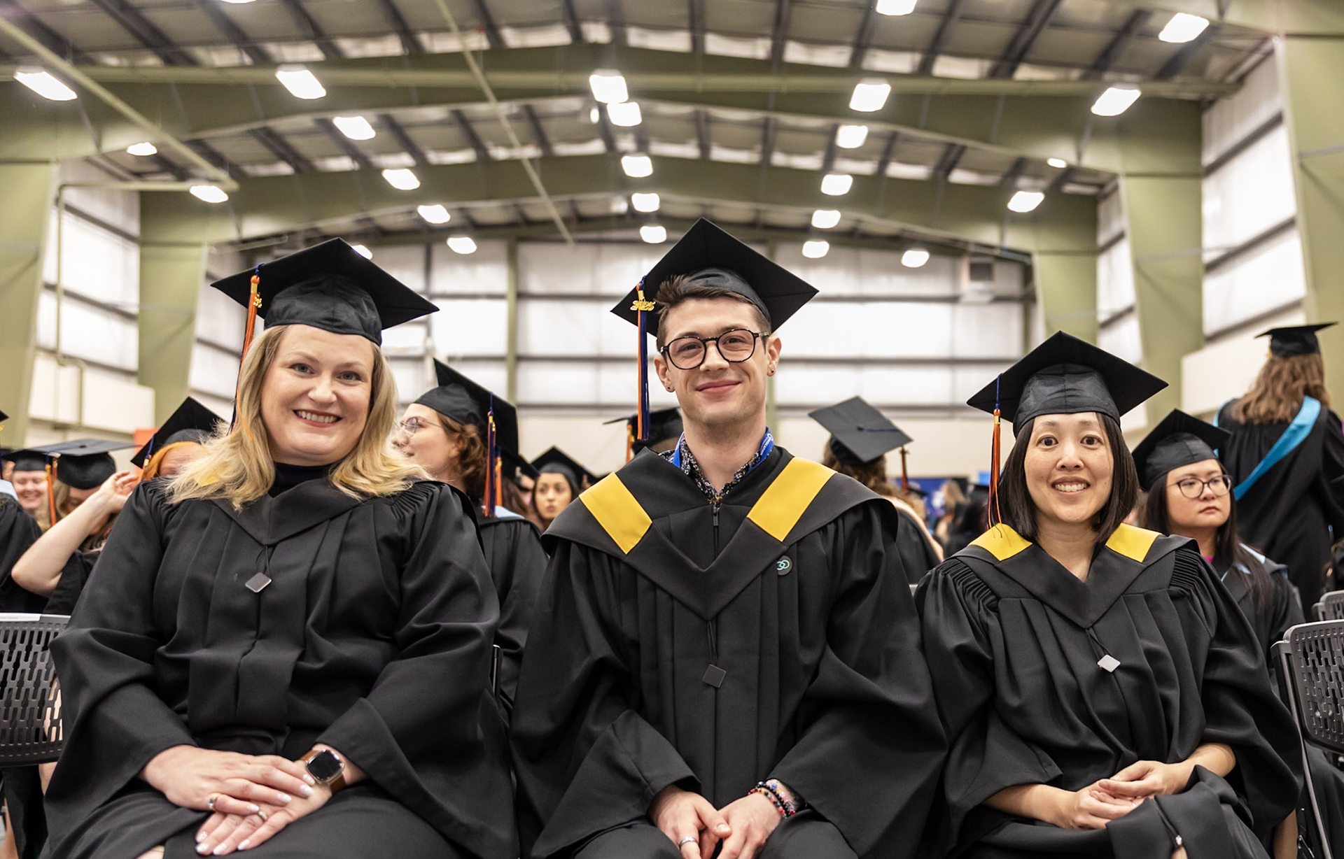 AU grads sitting together in a large room