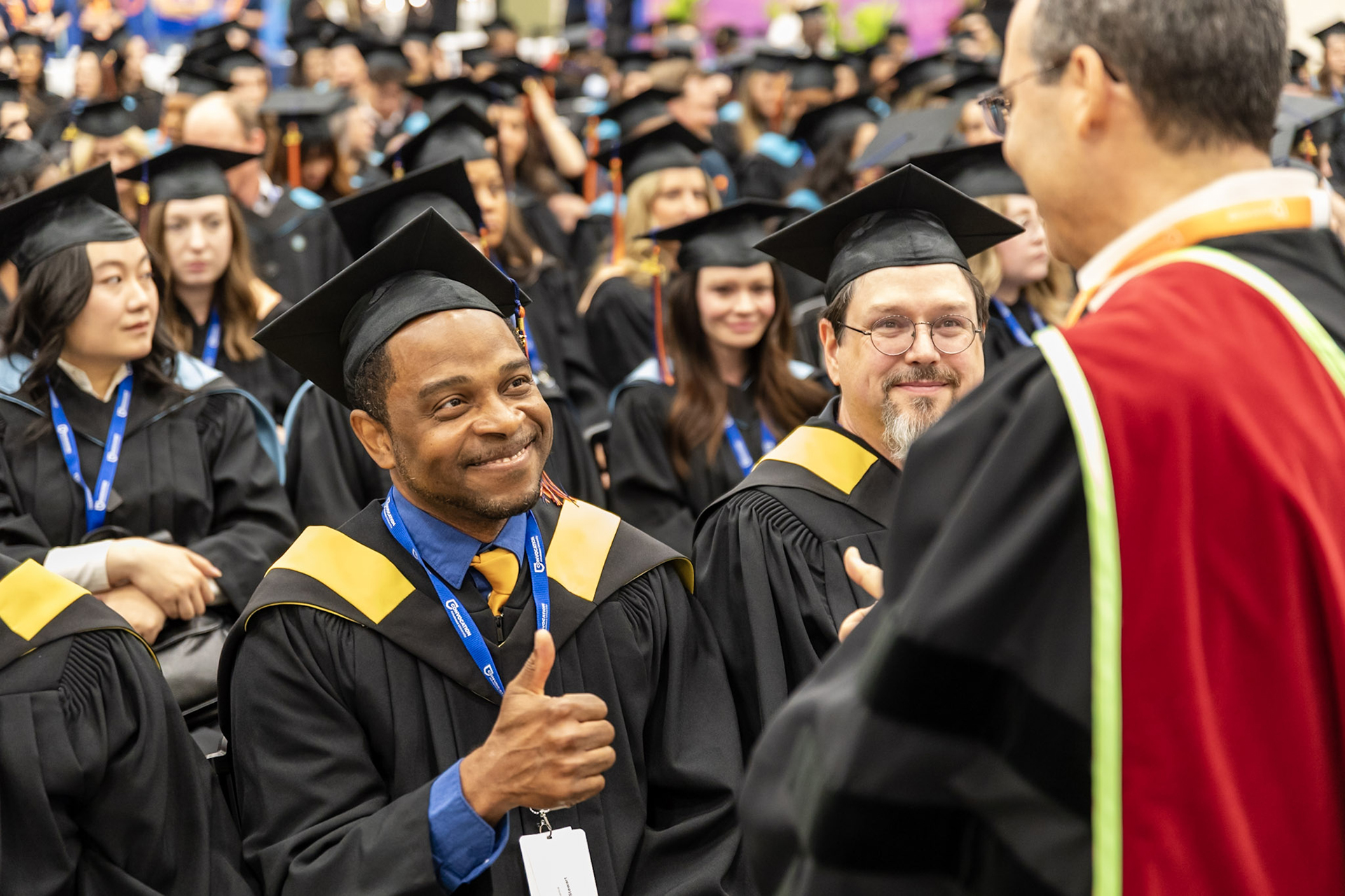 A grad gives a thumbs up to Chief Cadmus Delorme