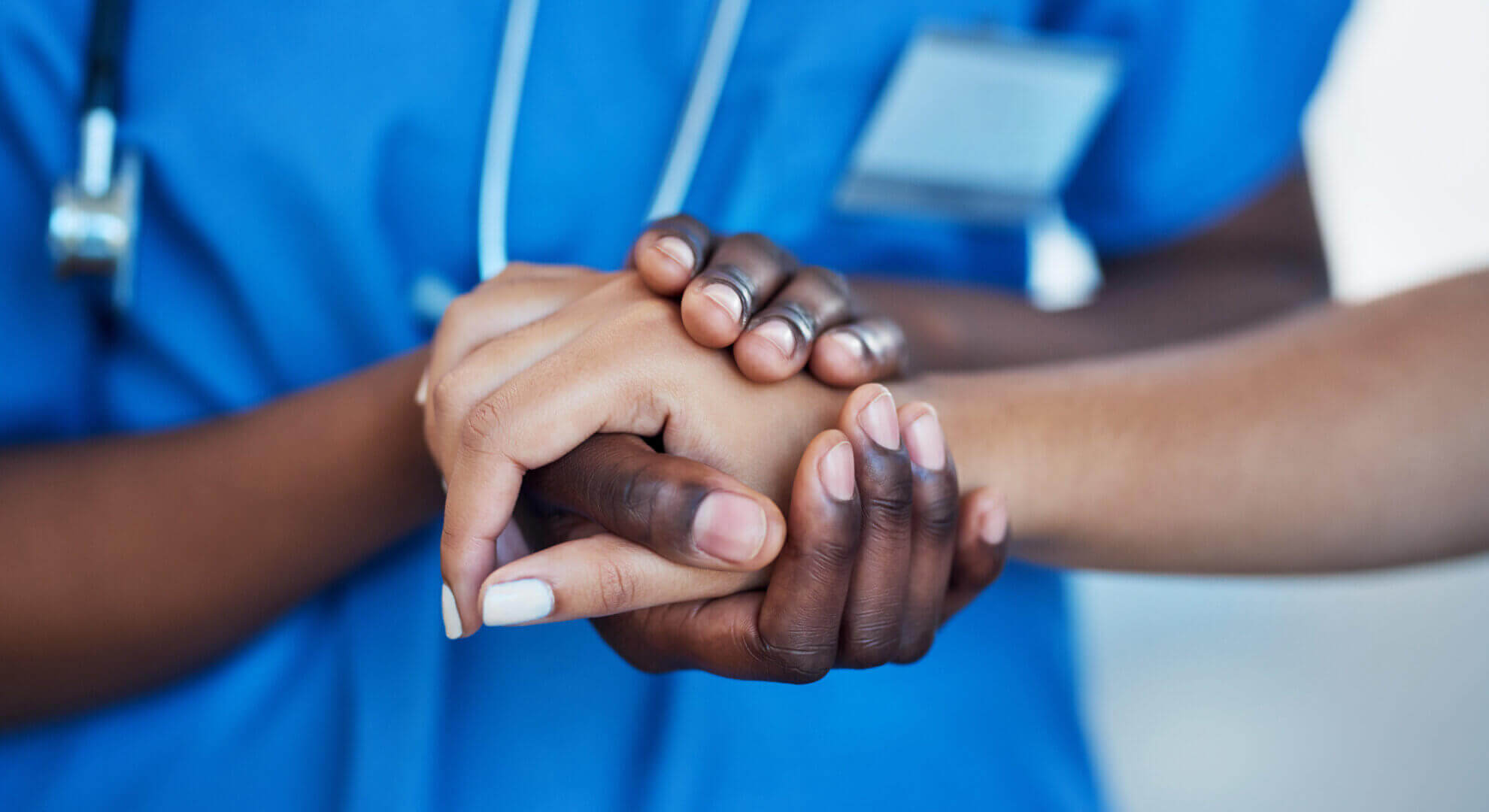 close-up of Black nurse holding a patient's hand close-up of Black nurse holding a patient's hand