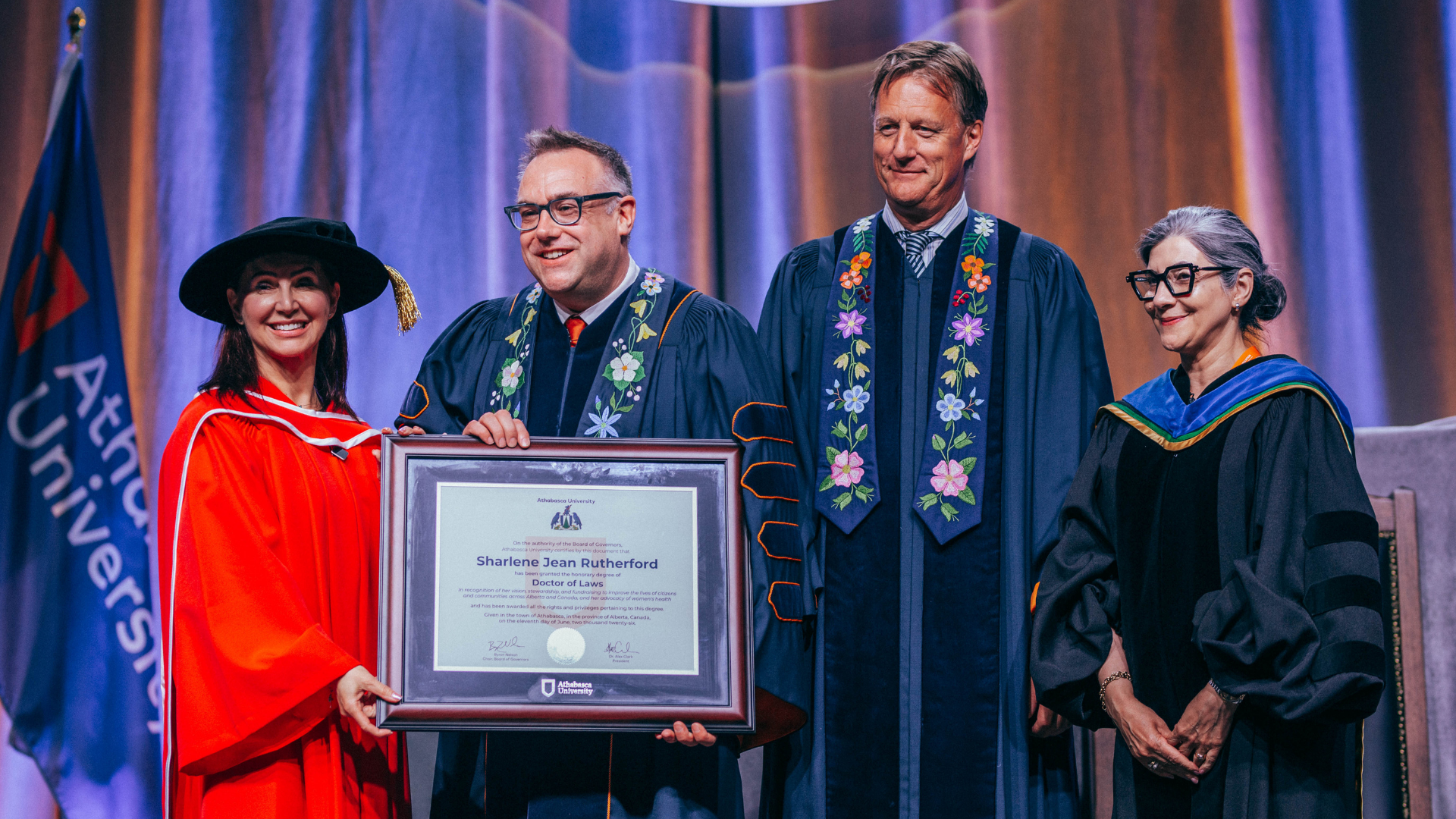 Honorary Doctorate receiving parchment from President Alex Clark