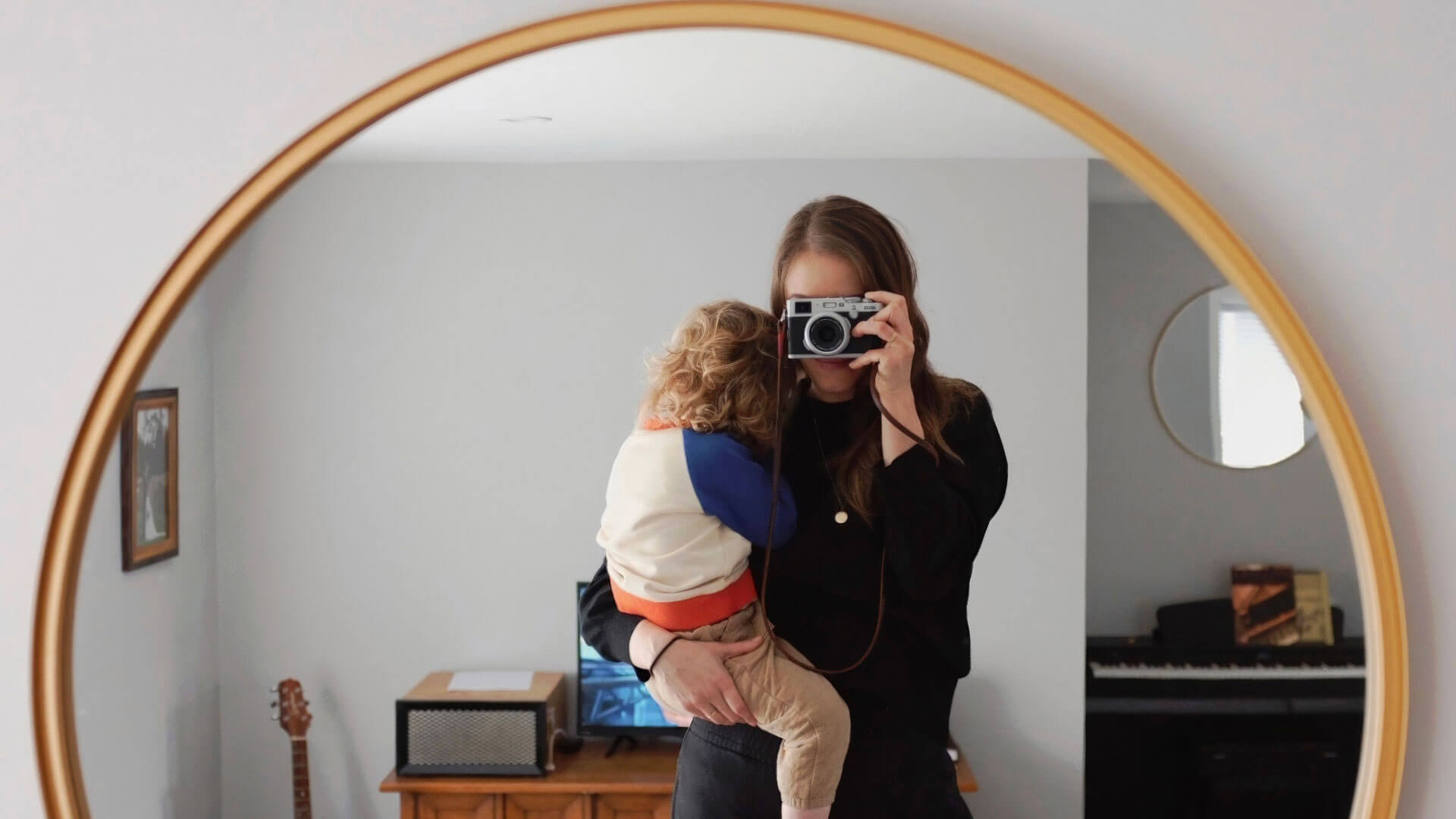 Kim Kimberlin takes photo of herself and her child in a mirror Kim Kimberlin takes photo of herself and her child in a mirror