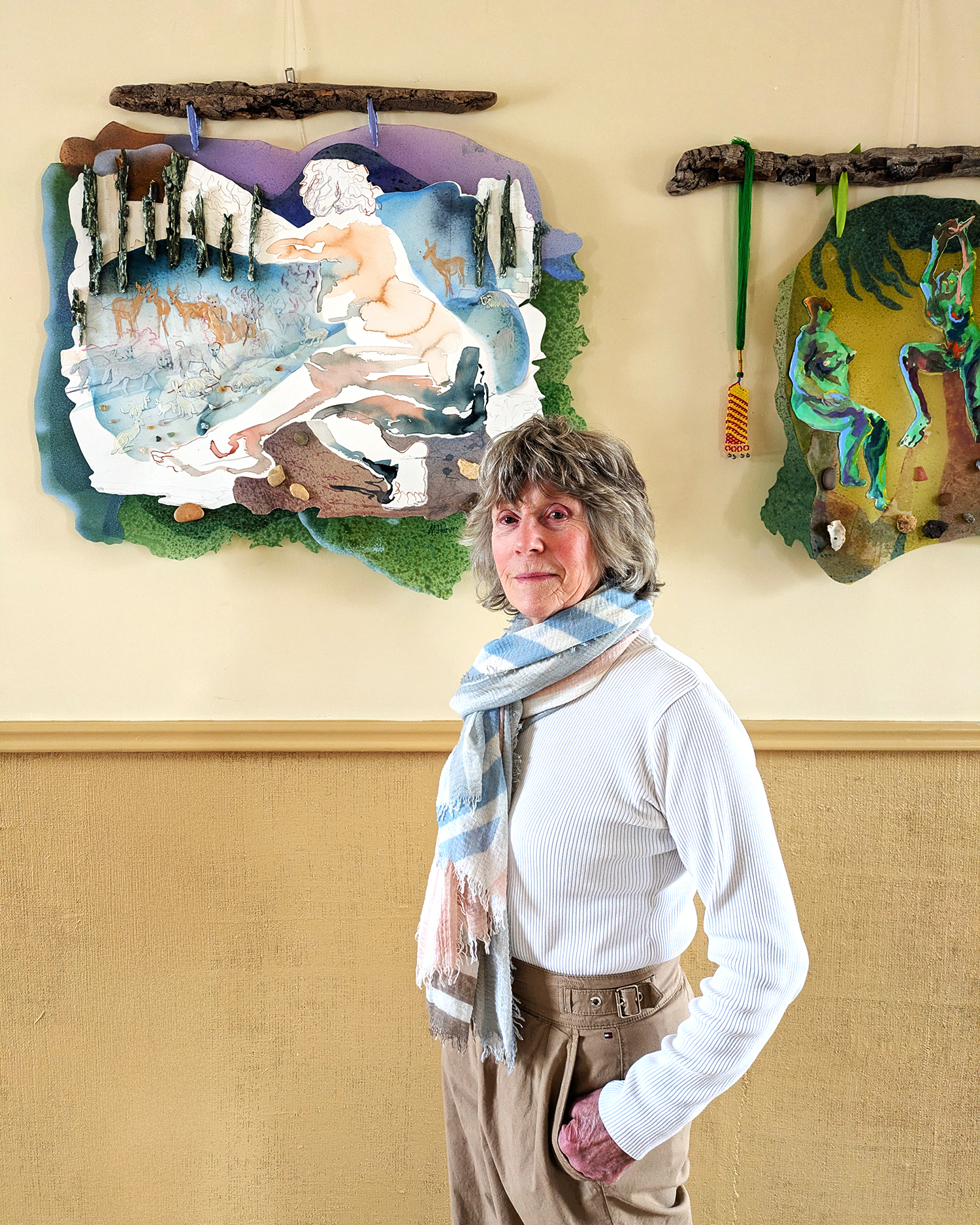 Maureen Harvey standing in front of her art
