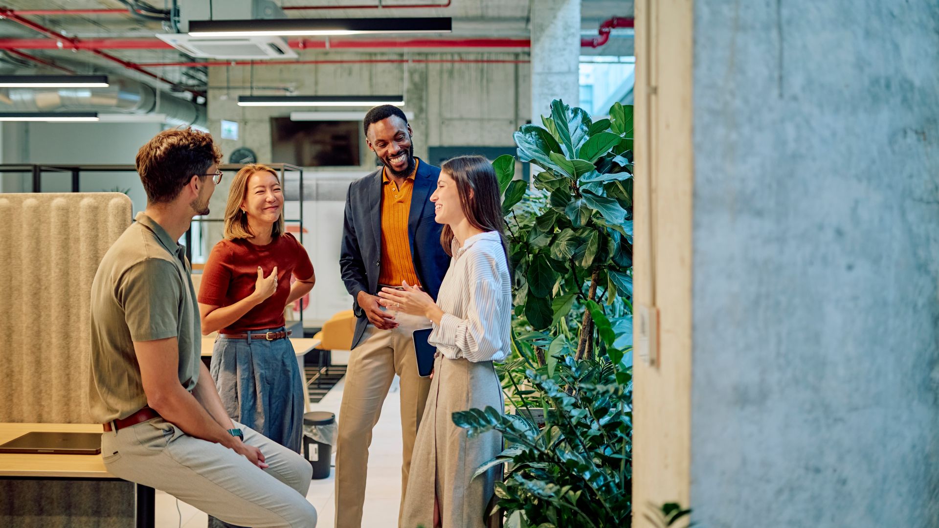 Team of architects discussing a new project in a modern office with plants