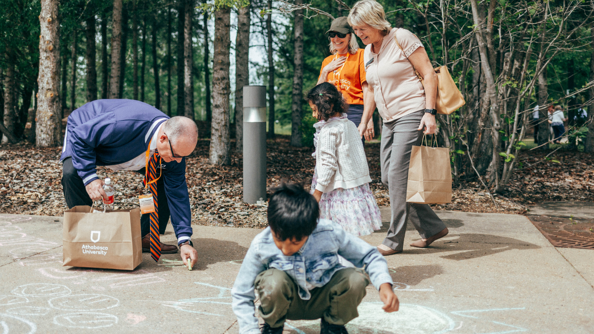 Staff and kids playing with chalk