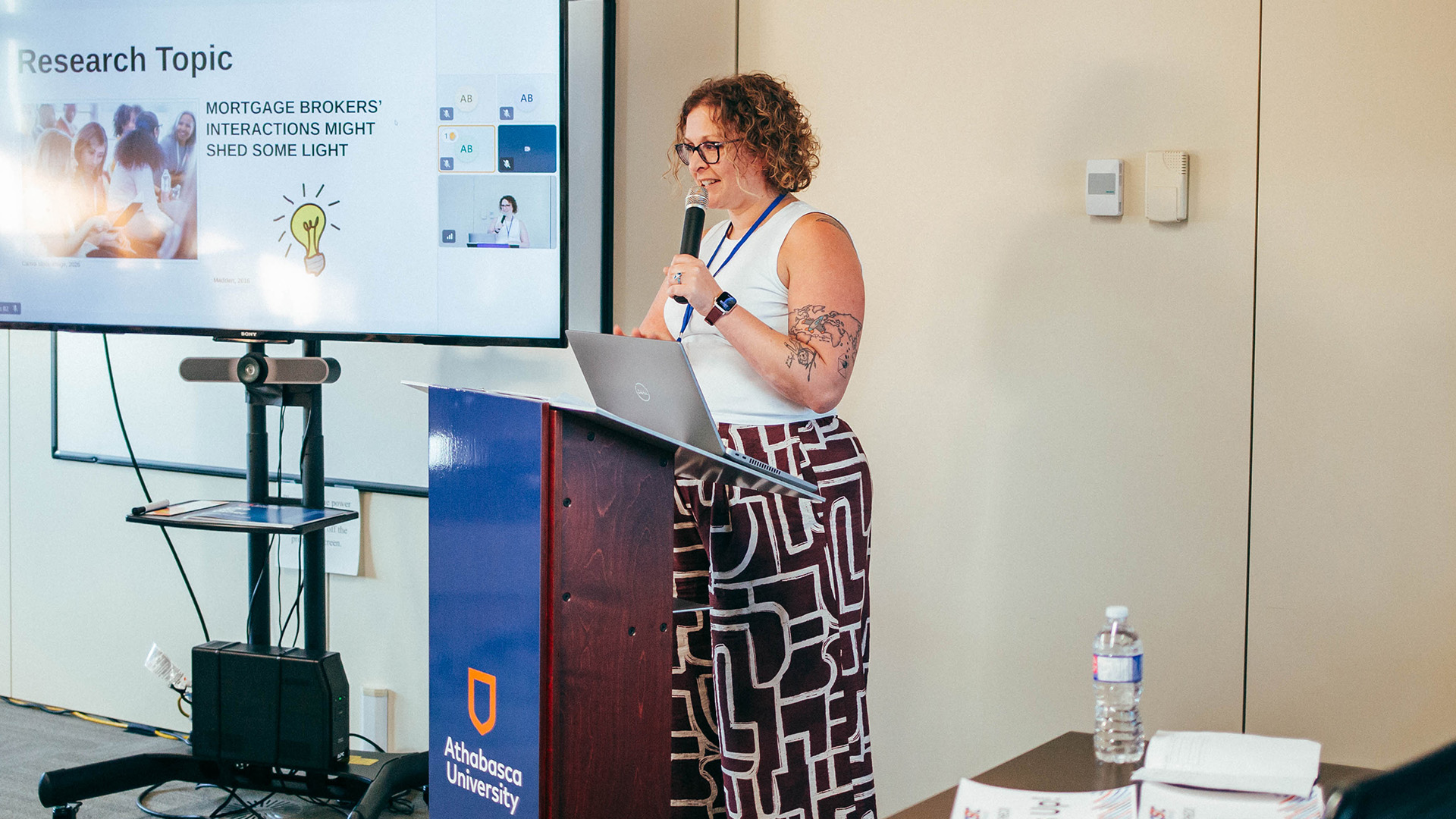 Student presents research findings in person in Athabasca