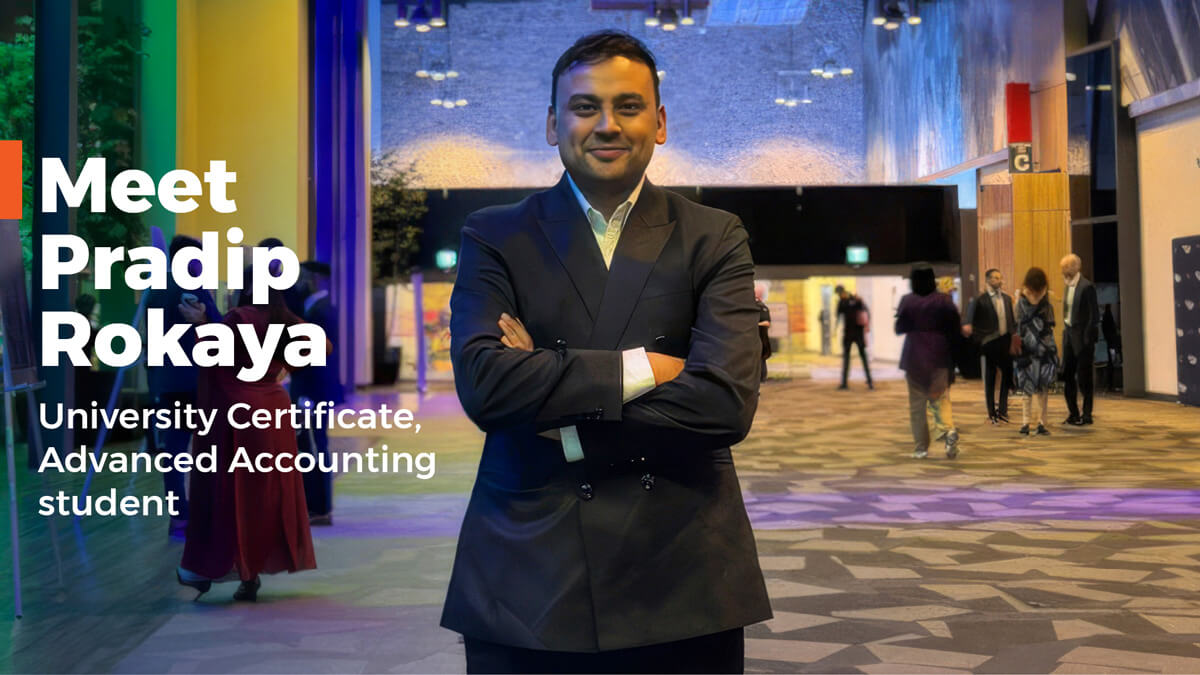 Pradip Roka standing with his arms crossed in a busy conference centre foyer