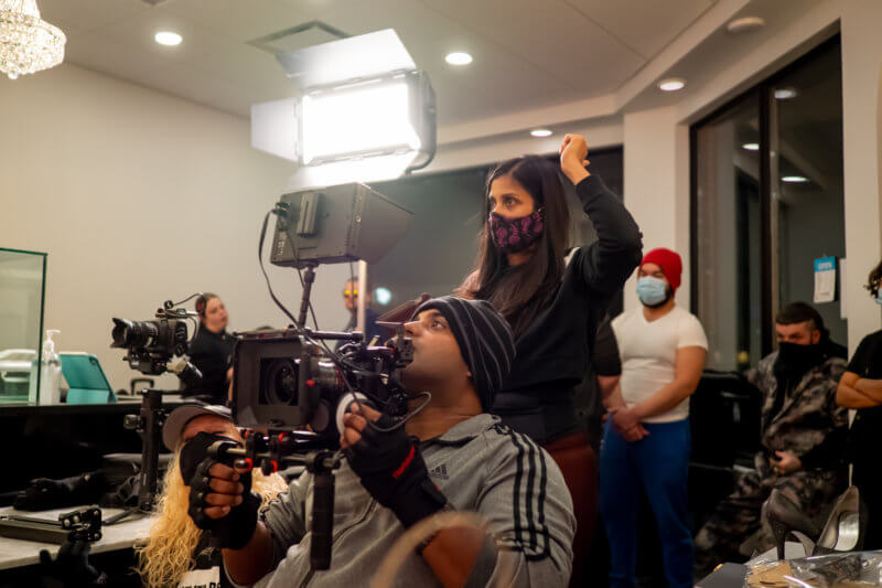 Cast wearing masks filming in a room