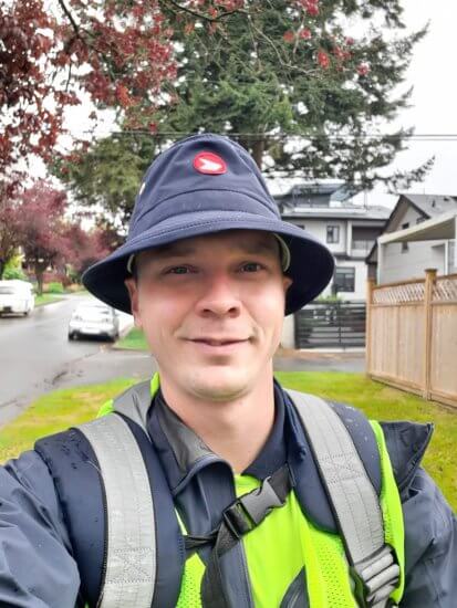 A selfie of Adam Lee wearing his Canada Post uniform while delivering the mail