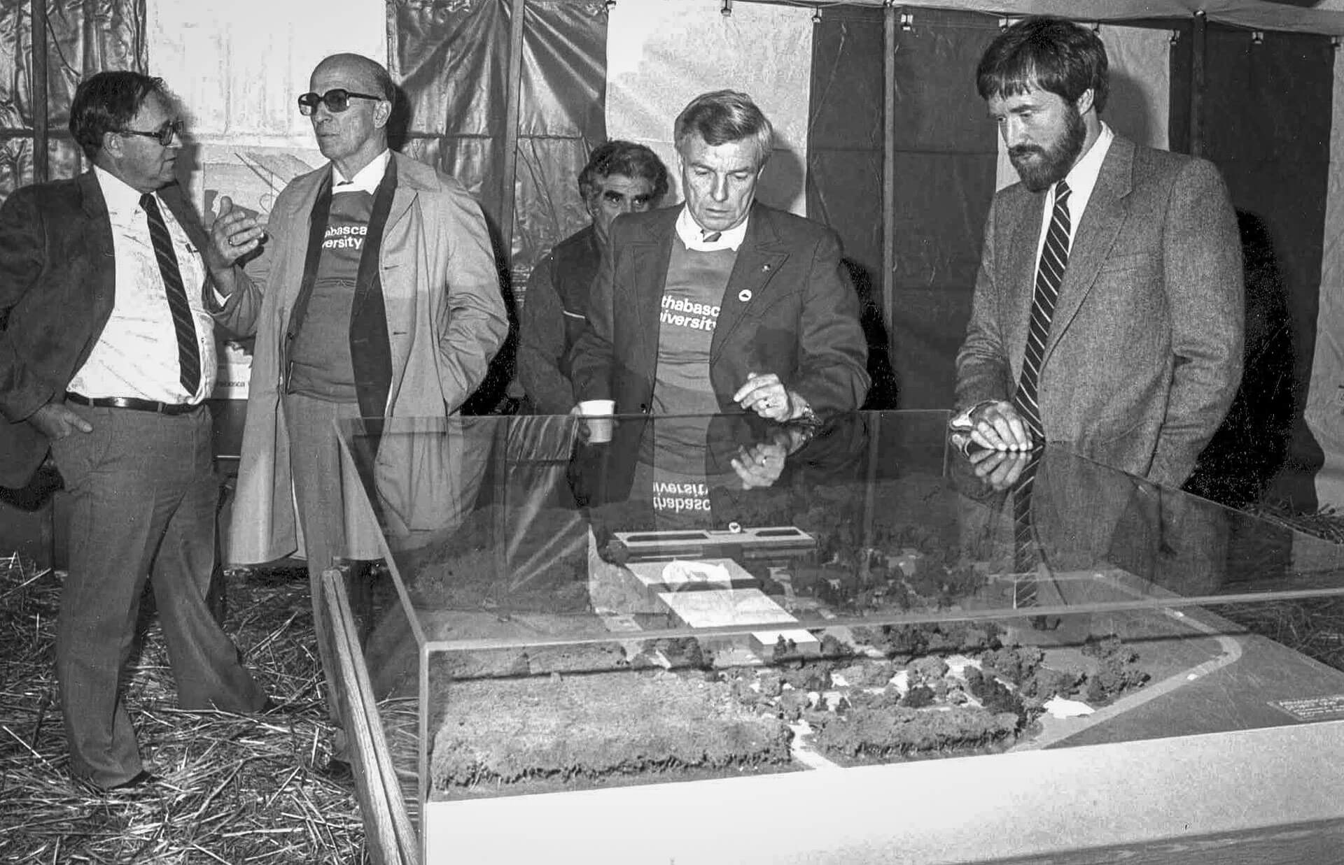 vintage photo of two men looking at a 3D model of campus