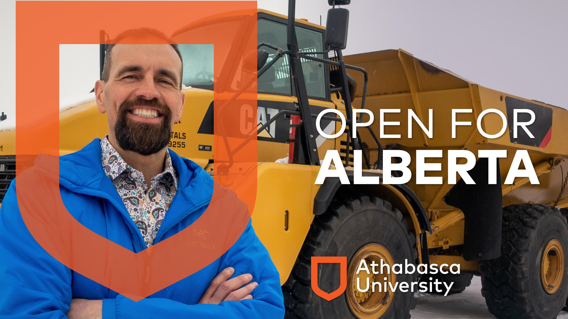 Bob Willows stands in front of heavy equipment with Open for Alberta graphics