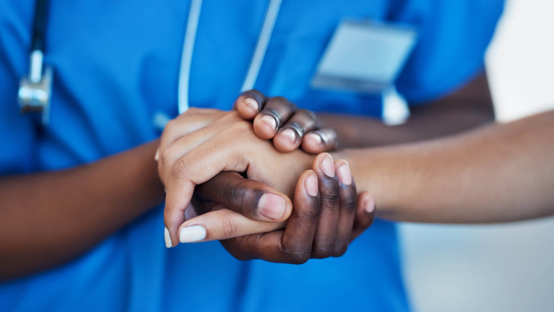 Closeup shot of a nurse holding a patient's hand in comfort