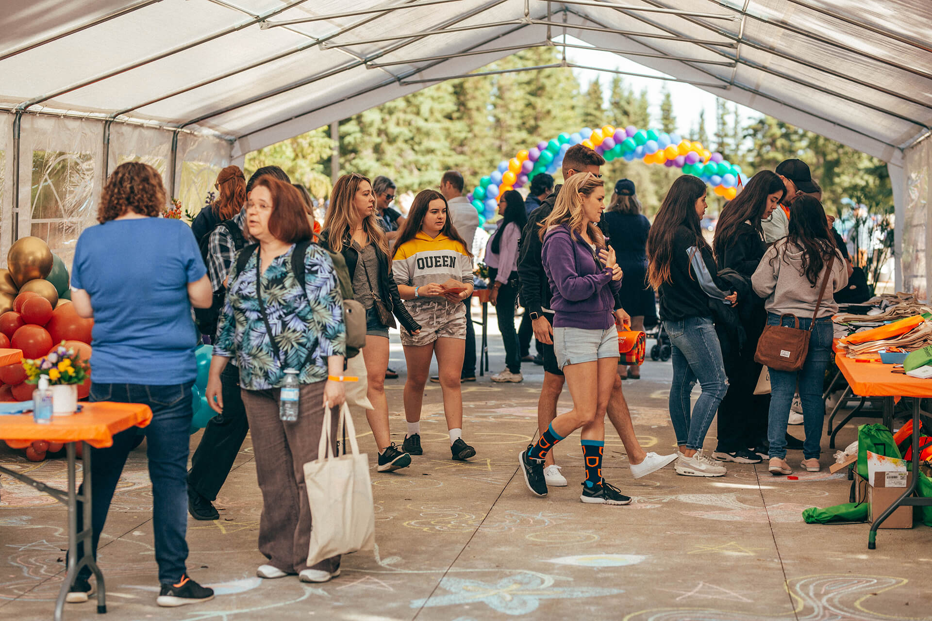 visitors in a tent at Athabasca University’s main campus for homecoming June 18.