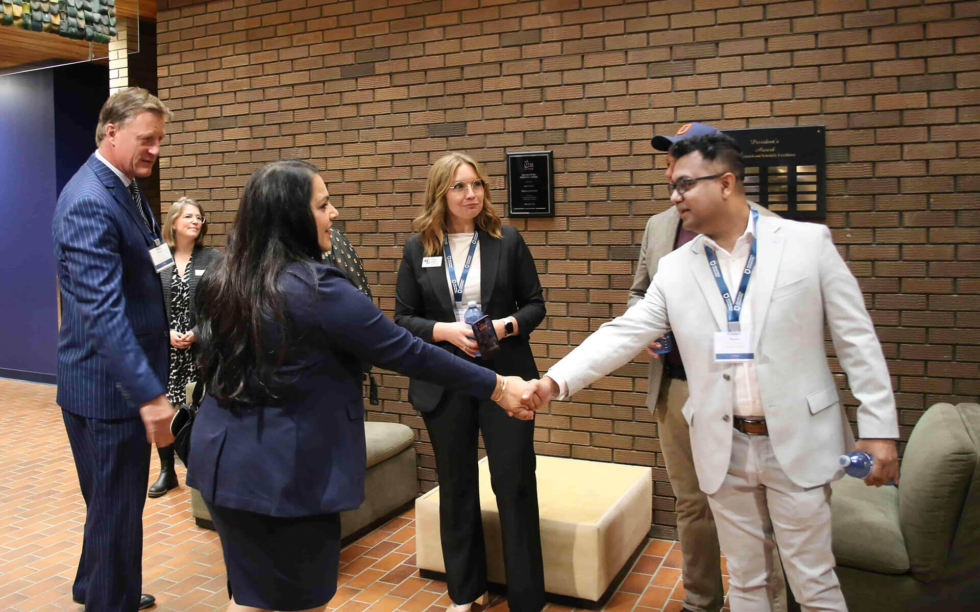 Rajan Sawhney shakes hands with an Athabasca University student