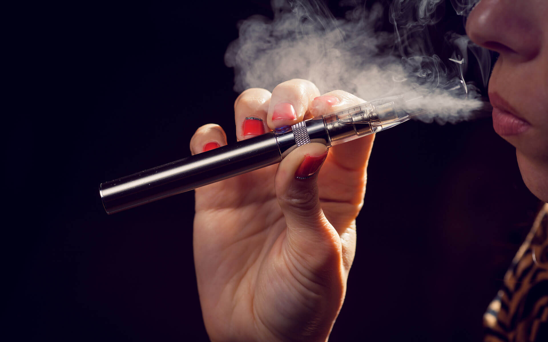 a close-up view of a person using a vape