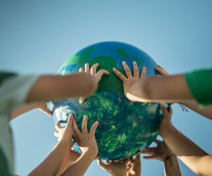 Children holding a planet outdoors