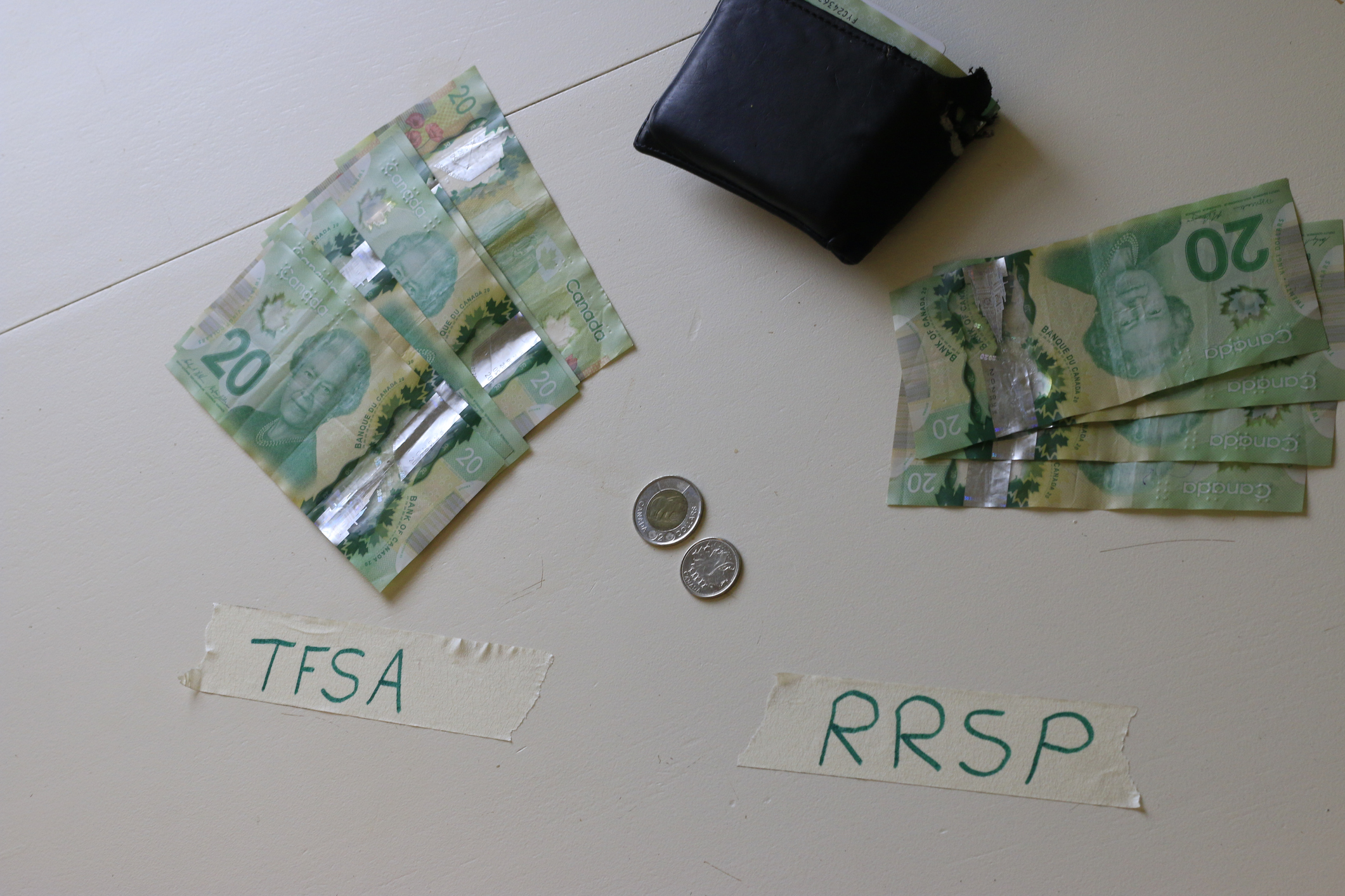 Financial concept depicting the choice between investing in TFSA or RRSP for Canadian.
