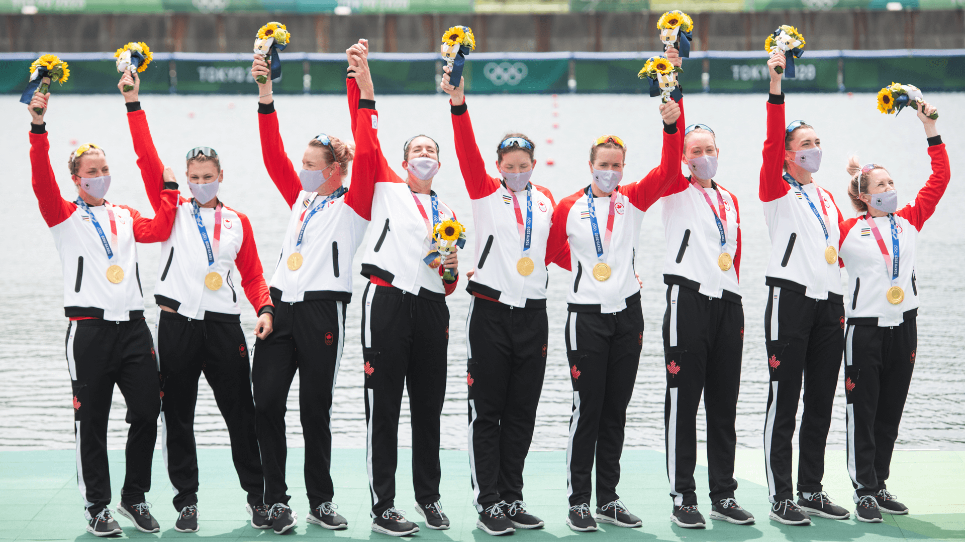 MerijnSoeters-lr-1005-banner Canadian women's eight rowing team with their gold medals and holding flowers