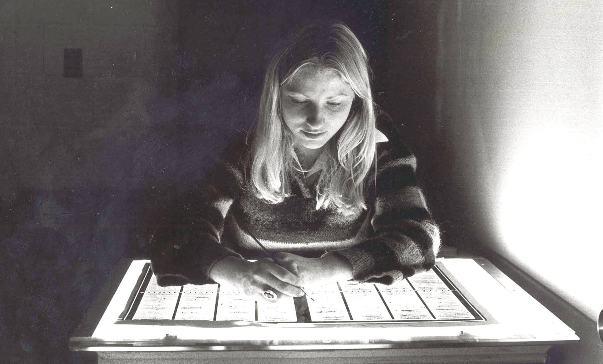 1991.056-00048 vintage photo of a woman at a light table