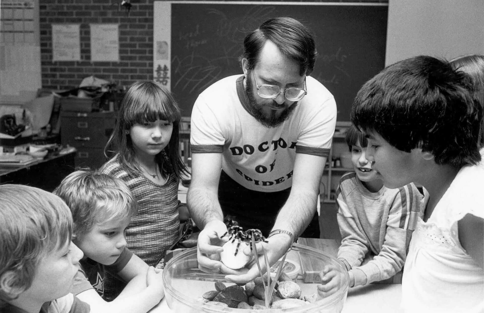 1991.056-07856 vintage photo of a man showing a tarantula to elementary students