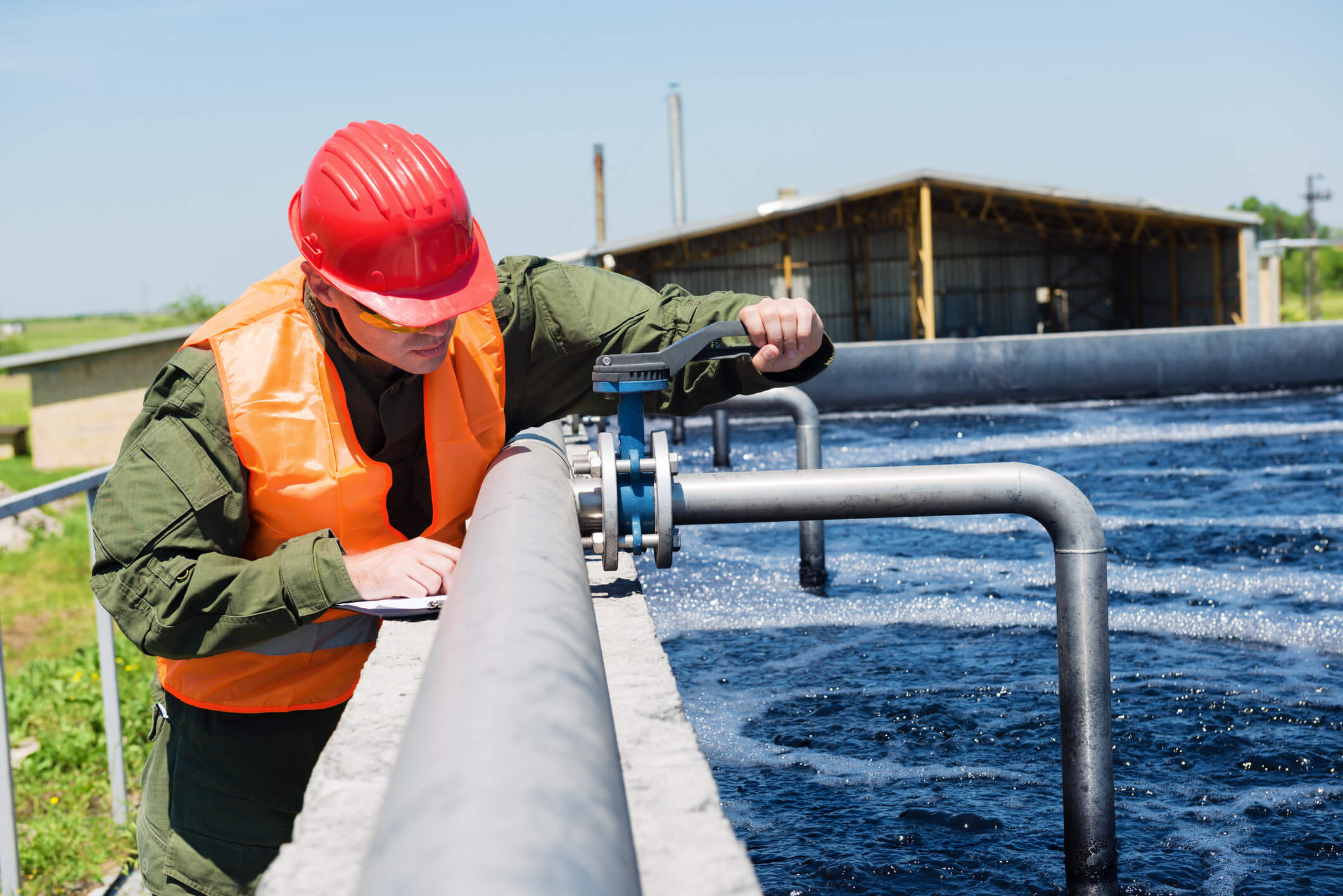 Waste water An engineer controlling the quality of water , aerated activated sludge tank at a waste water treatment plant