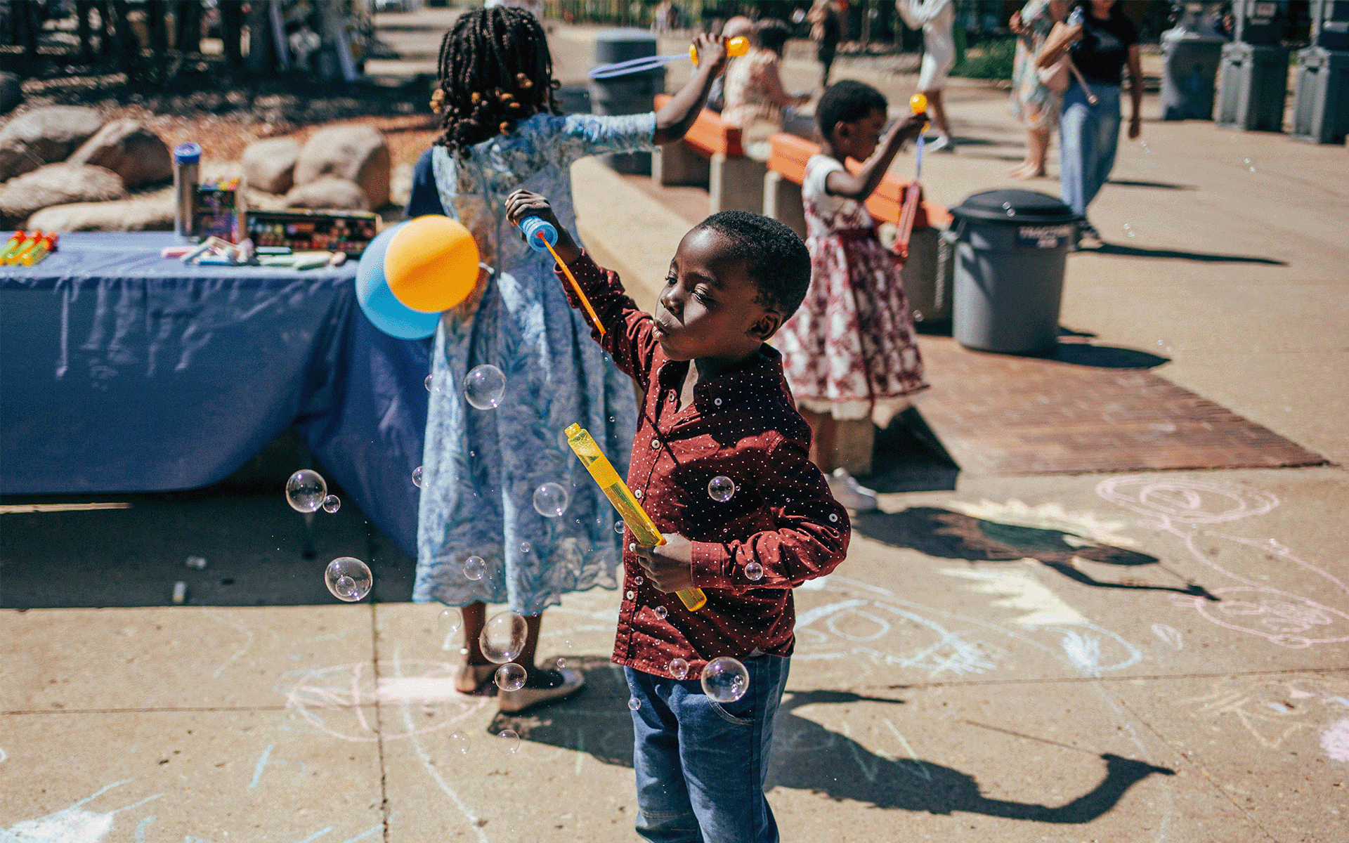 Blowing bubbles Young child playing with bubbles at the convocation festival after the ceremonies
