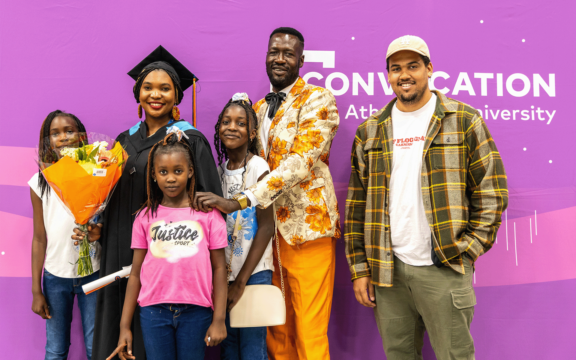 grad with family family photo with graduate at convocation